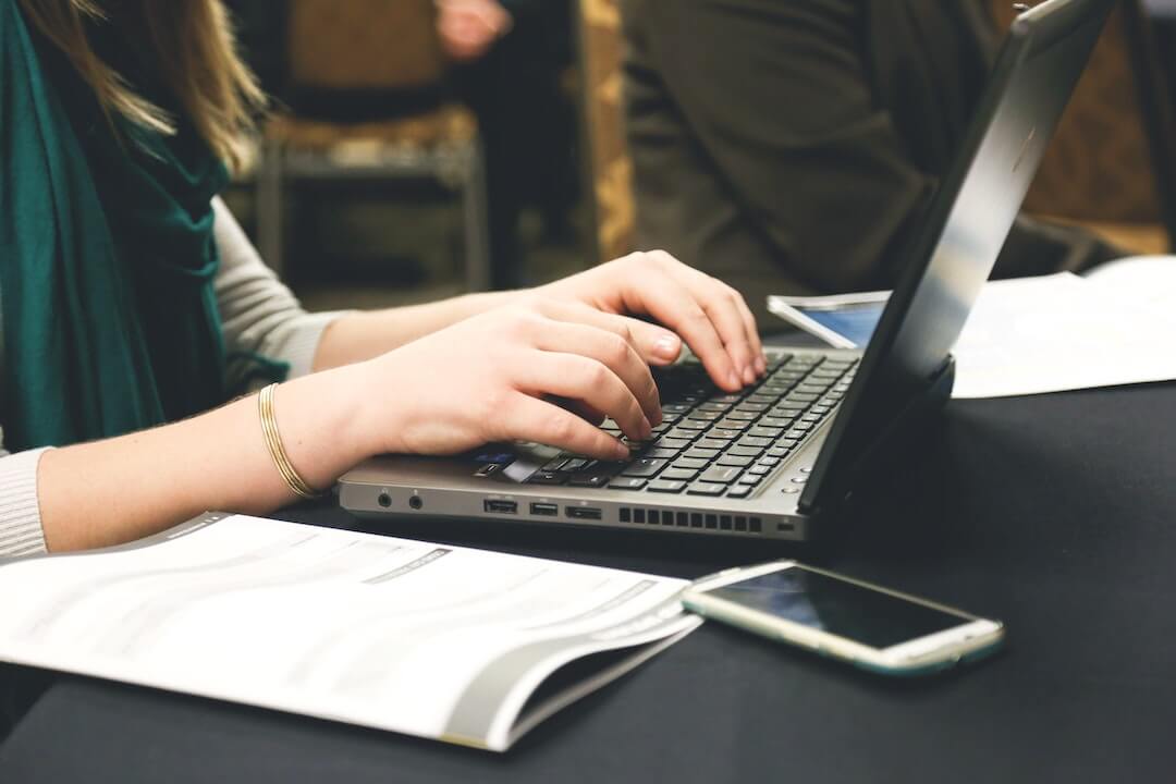 woman typing on old computer